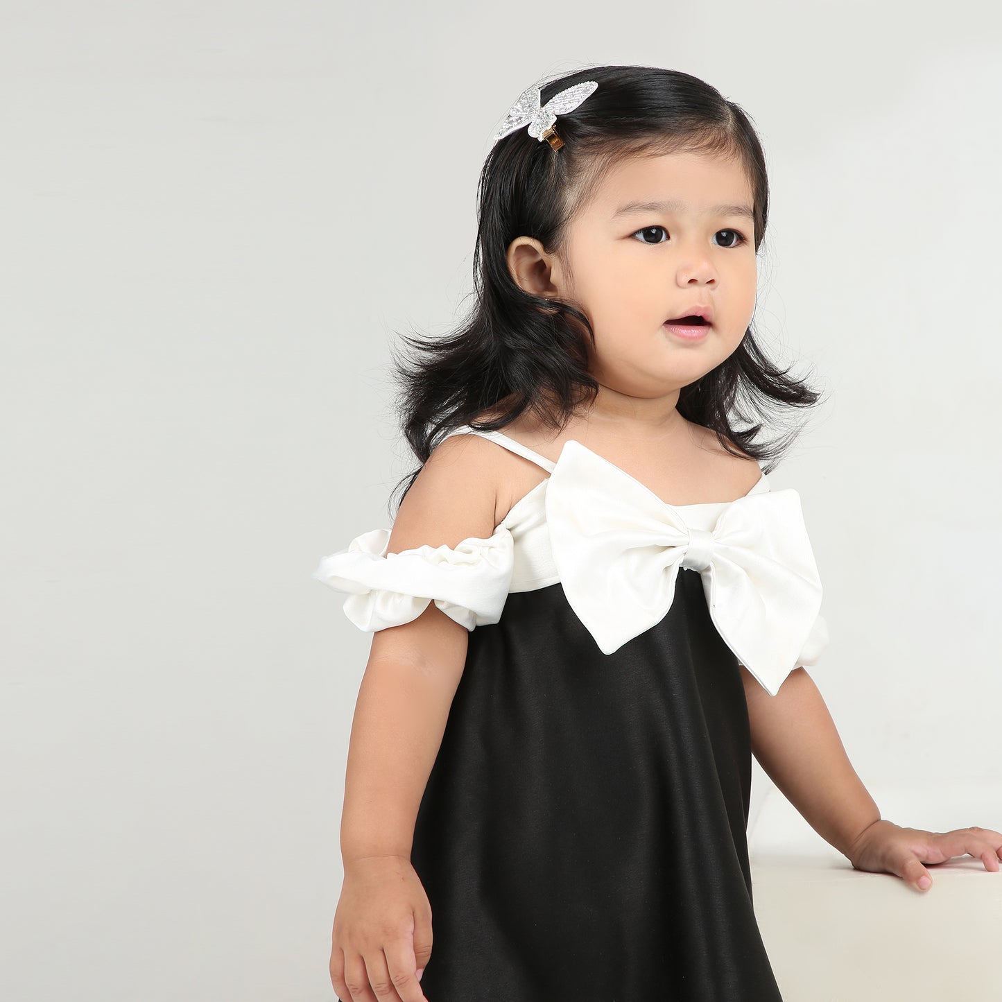 Elegant black party dress for girls with stylish white bow and sleeves