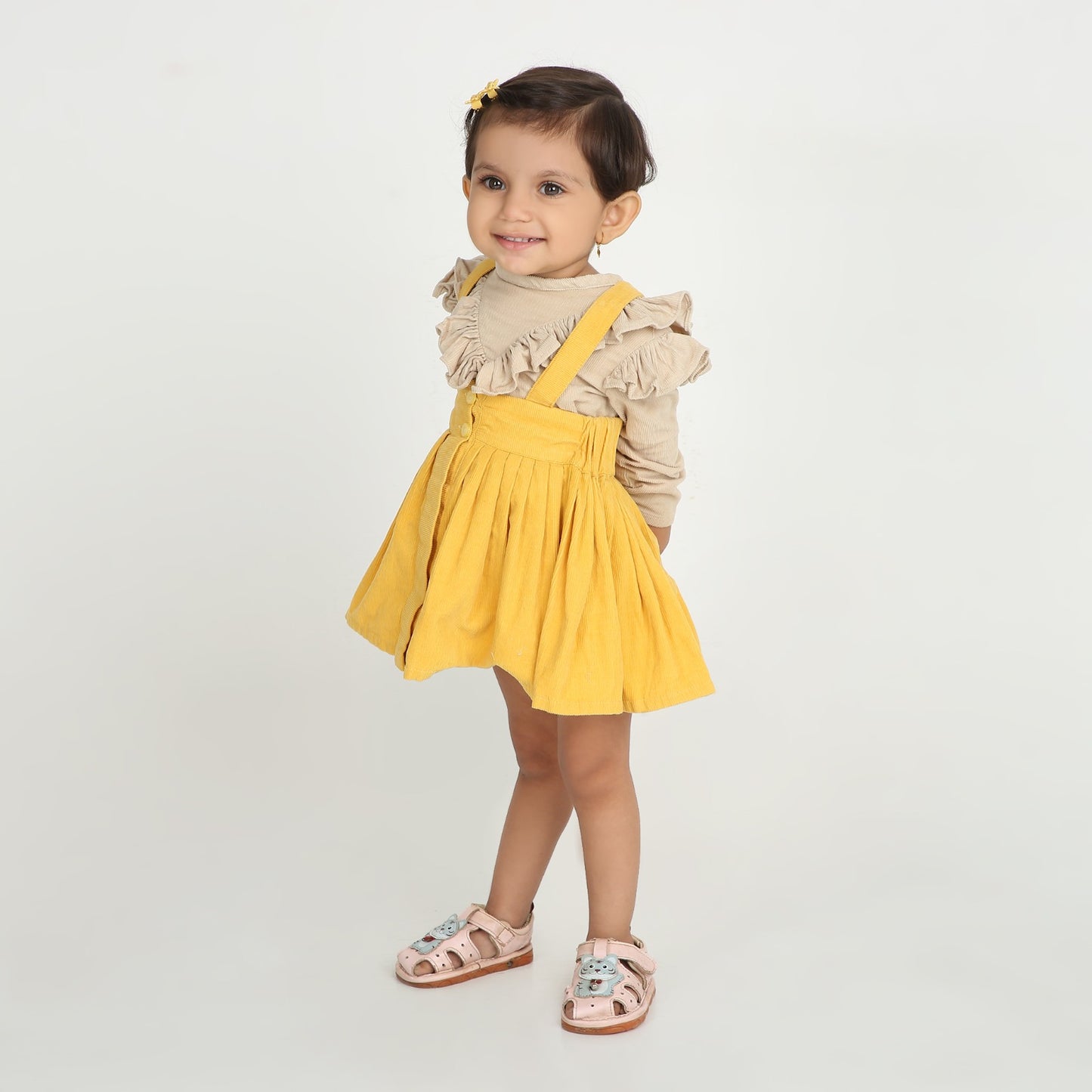 Stylish dungaree skirt paired with a cute ruffle top