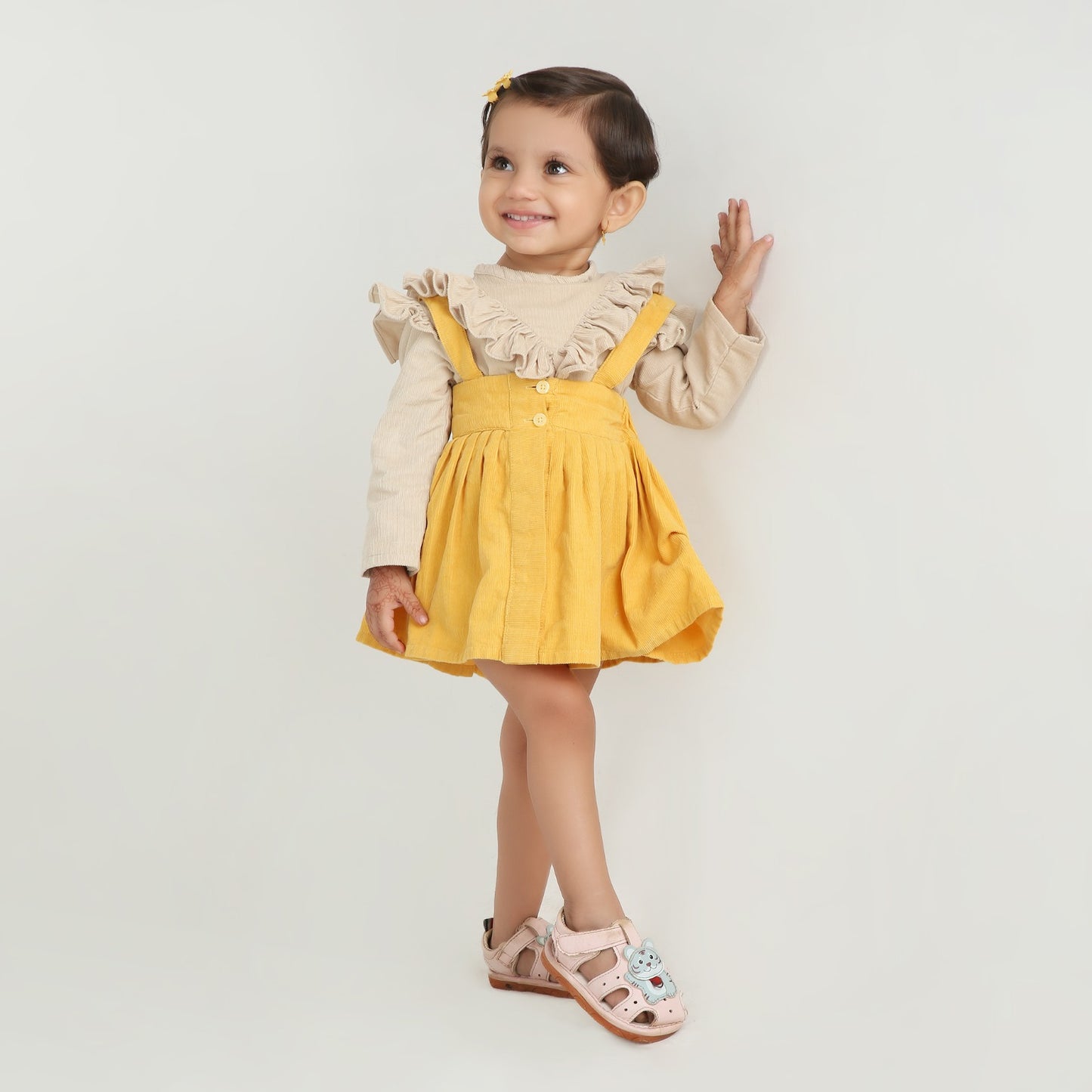 Stylish dungaree skirt paired with a cute ruffle top