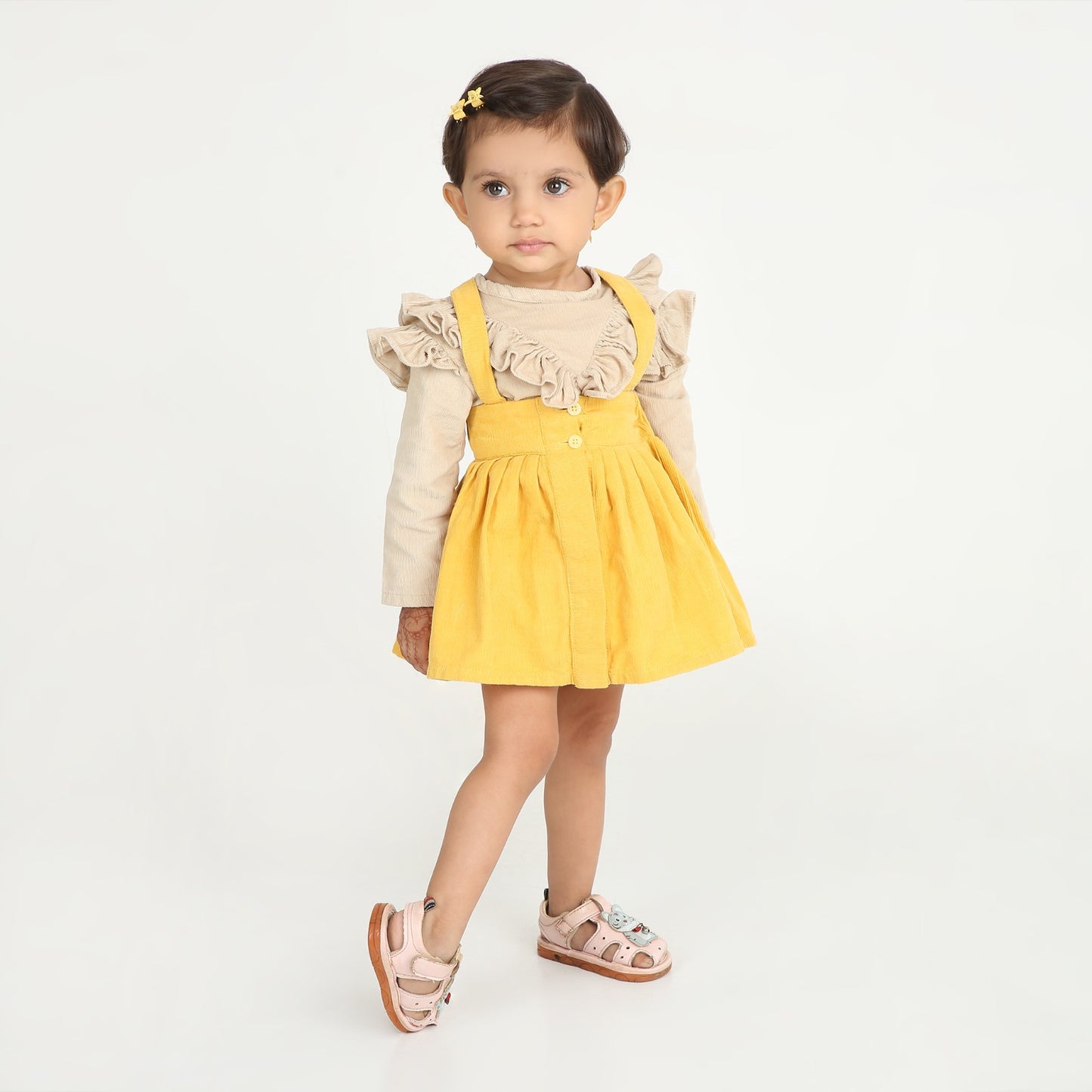 Stylish dungaree skirt paired with a cute ruffle top