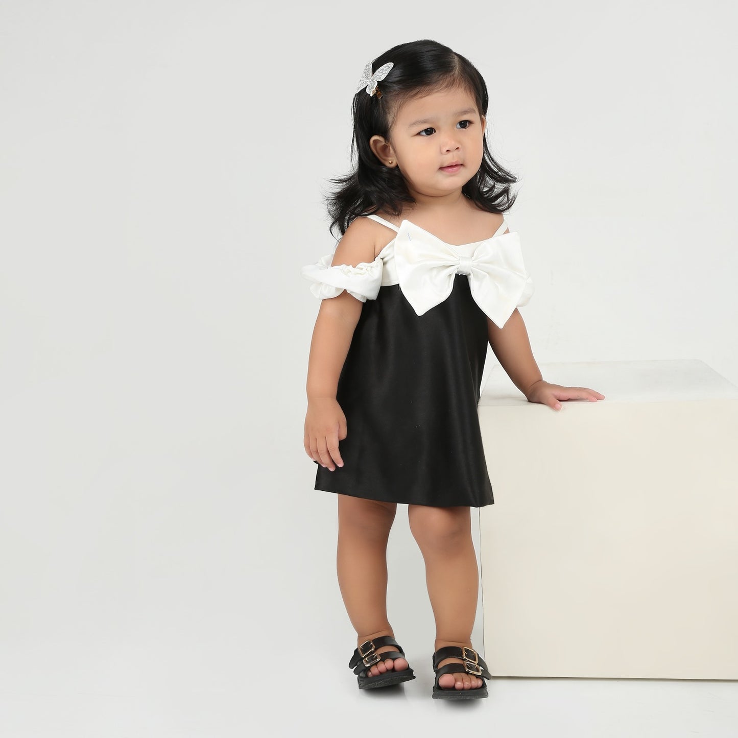 Elegant black party dress for girls with stylish white bow and sleeves